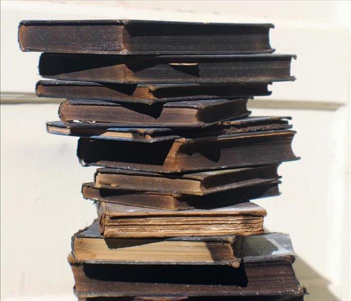 A stack of old, partially-burned books